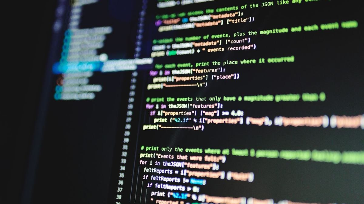 Close-up of colourful programming code on a dark computer screen